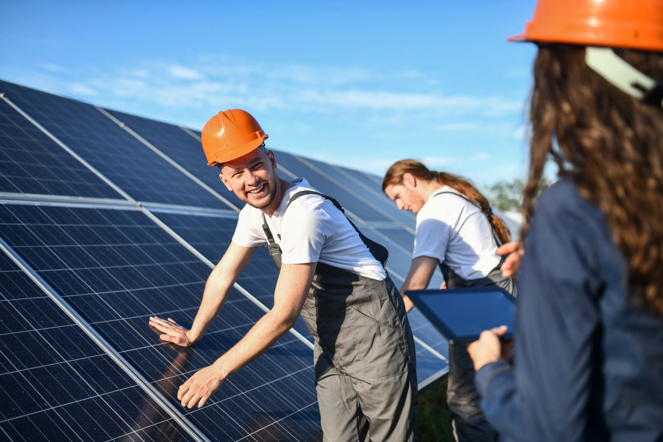 Solar installers working on rooftop panels