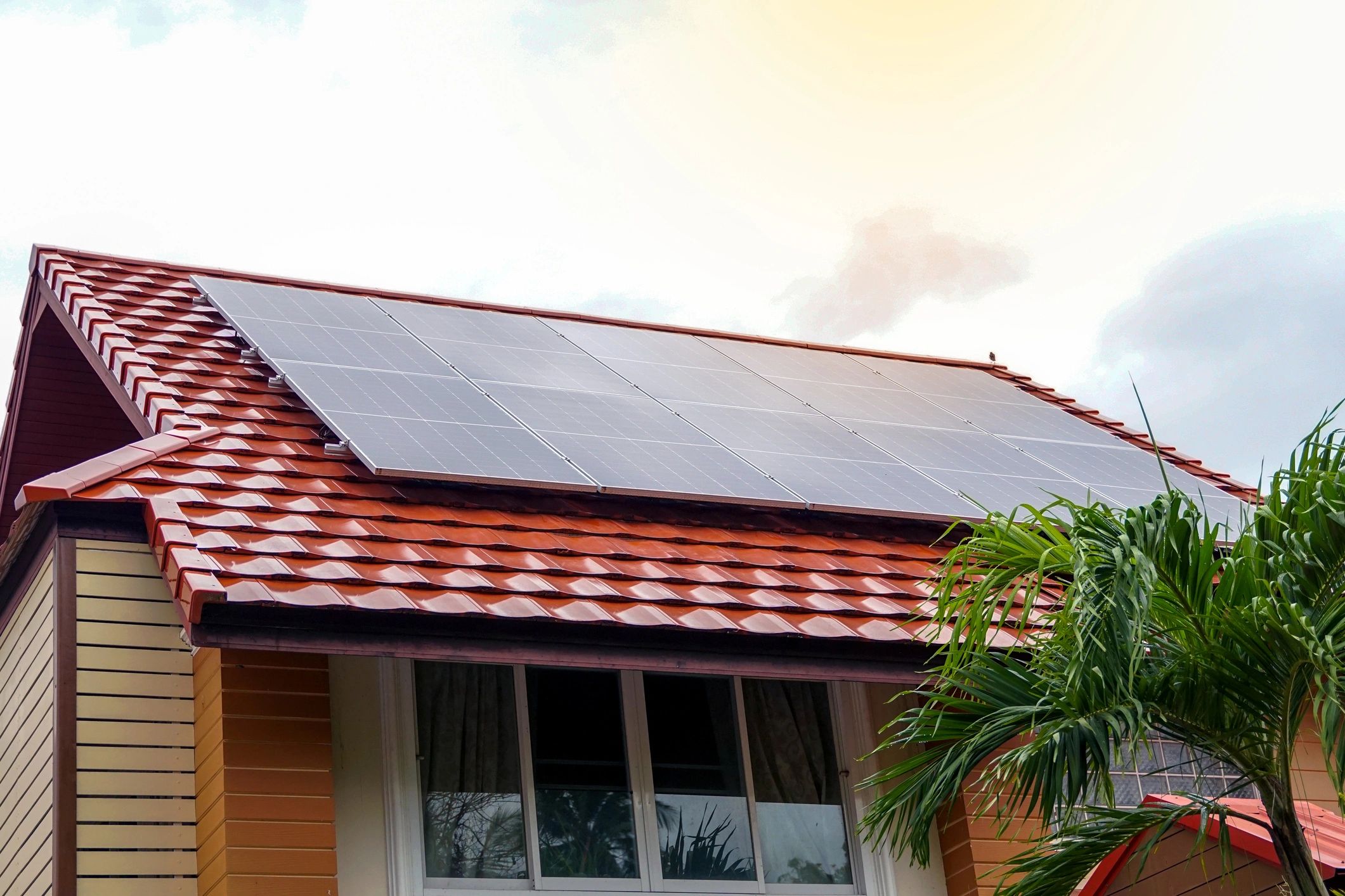 Rooftop solar array on a modern home used for solar FAQ guidance